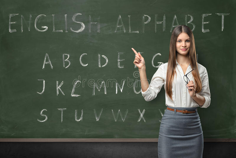 attractive-young-woman-teacher-classroom-teaching-english-language-hand-written-alphabet-chalkboard-76016945.jpg
